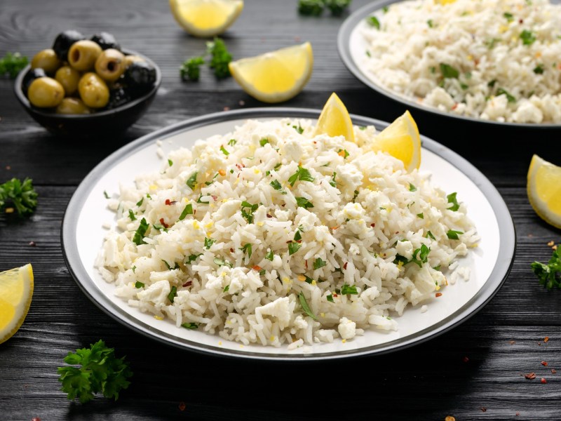 Ein Teller griechischer Feta-Reis, serviert mit Zitrone.
